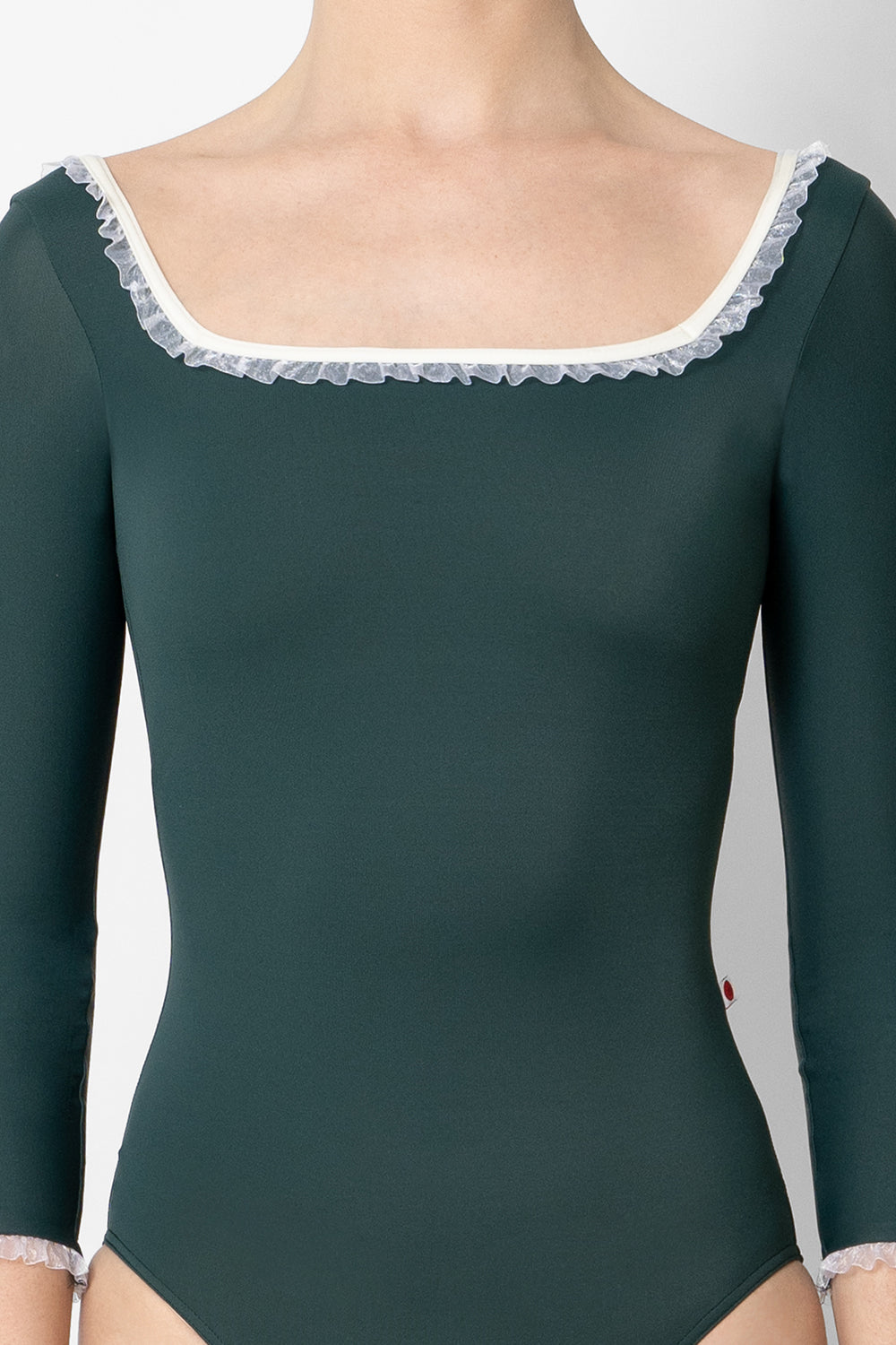 Marieke leotard in T-Kale body color with 3Q sleeves, N-Antique trim color and White Ruffle