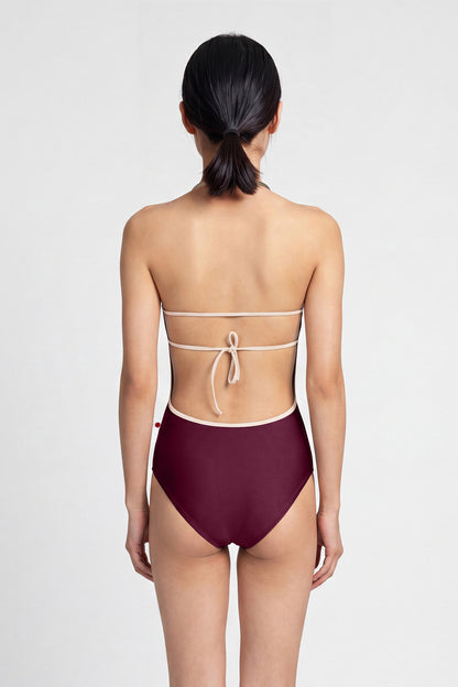AI-generated model. Kate leotard, burgundy with a scoop neckline and strappy back.