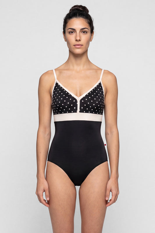 AI-generated model. Zoe leotard, black T-Lunares polka-dot V-neck bust with blush straps and waistband, black body.
