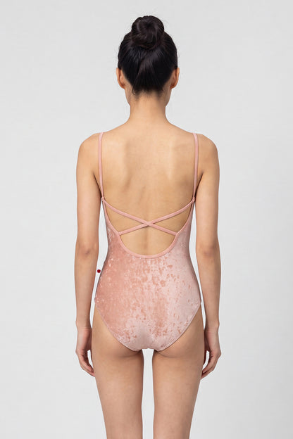 AI-generated model. Daniela leotard, all-over dusty-rose crushed velvet with a scoop neck and thin straps.