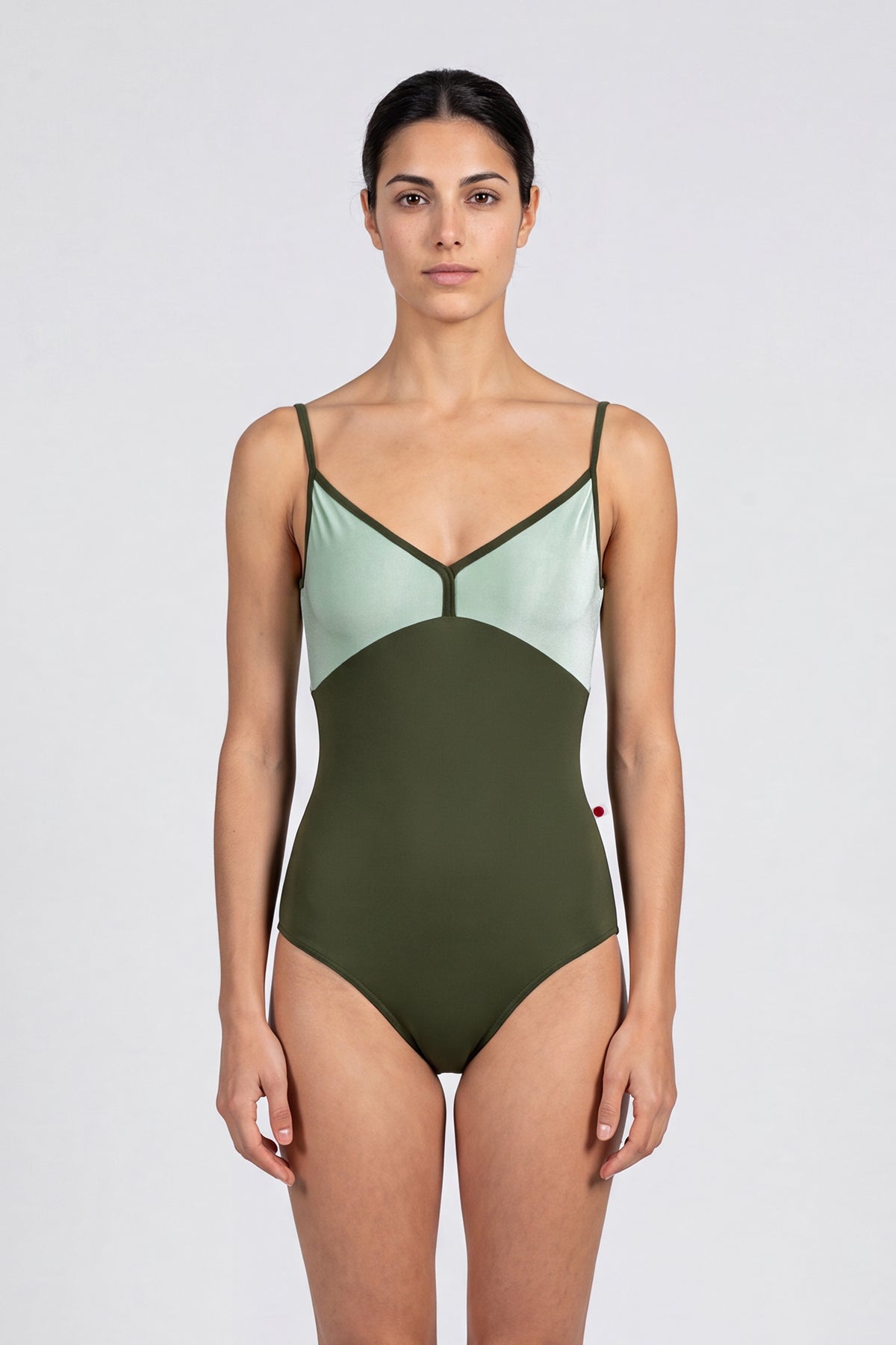 AI-generated model. Daria leotard, mint crushed-velvet bodice and an olive-green body, V-neck with thin olive straps.