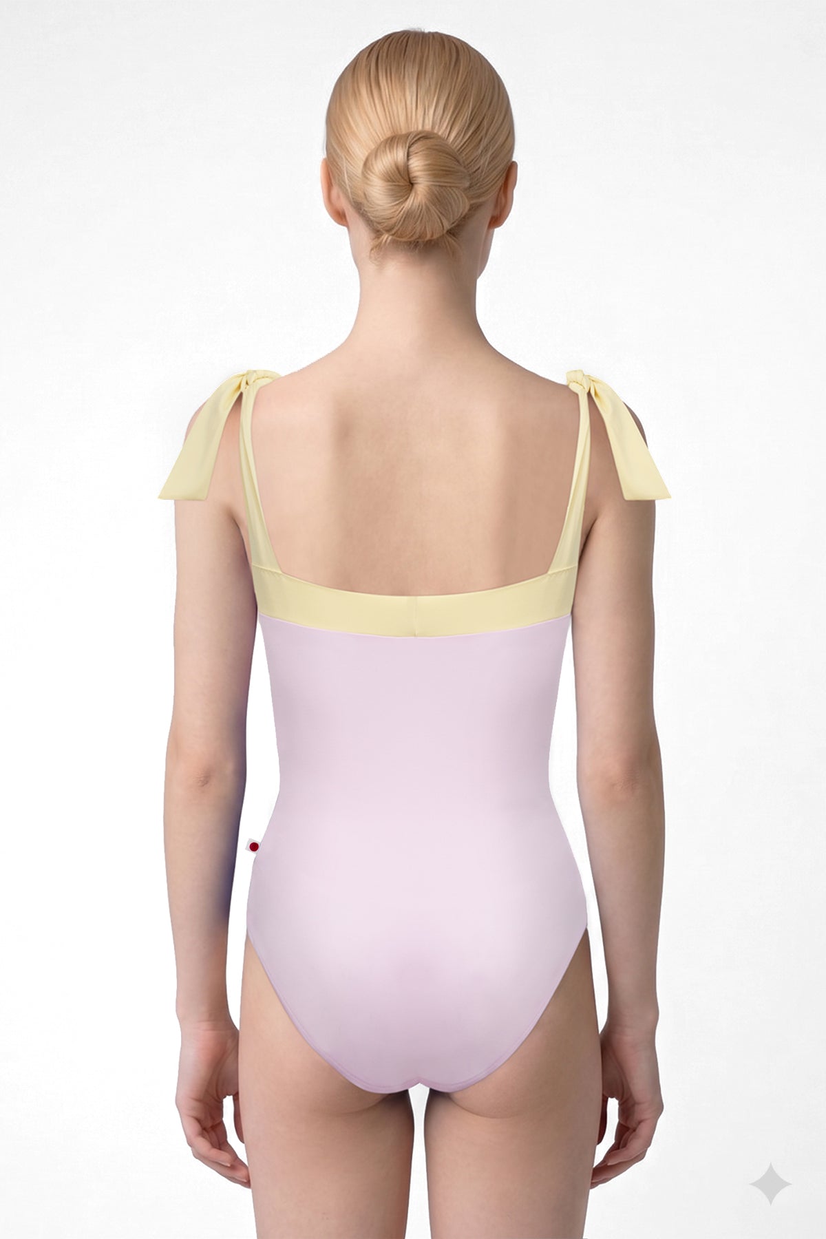 AI-generated model. Mimi leotard, dusty pink body with a pale-yellow top band and knotted tie shoulder straps, square neckline.