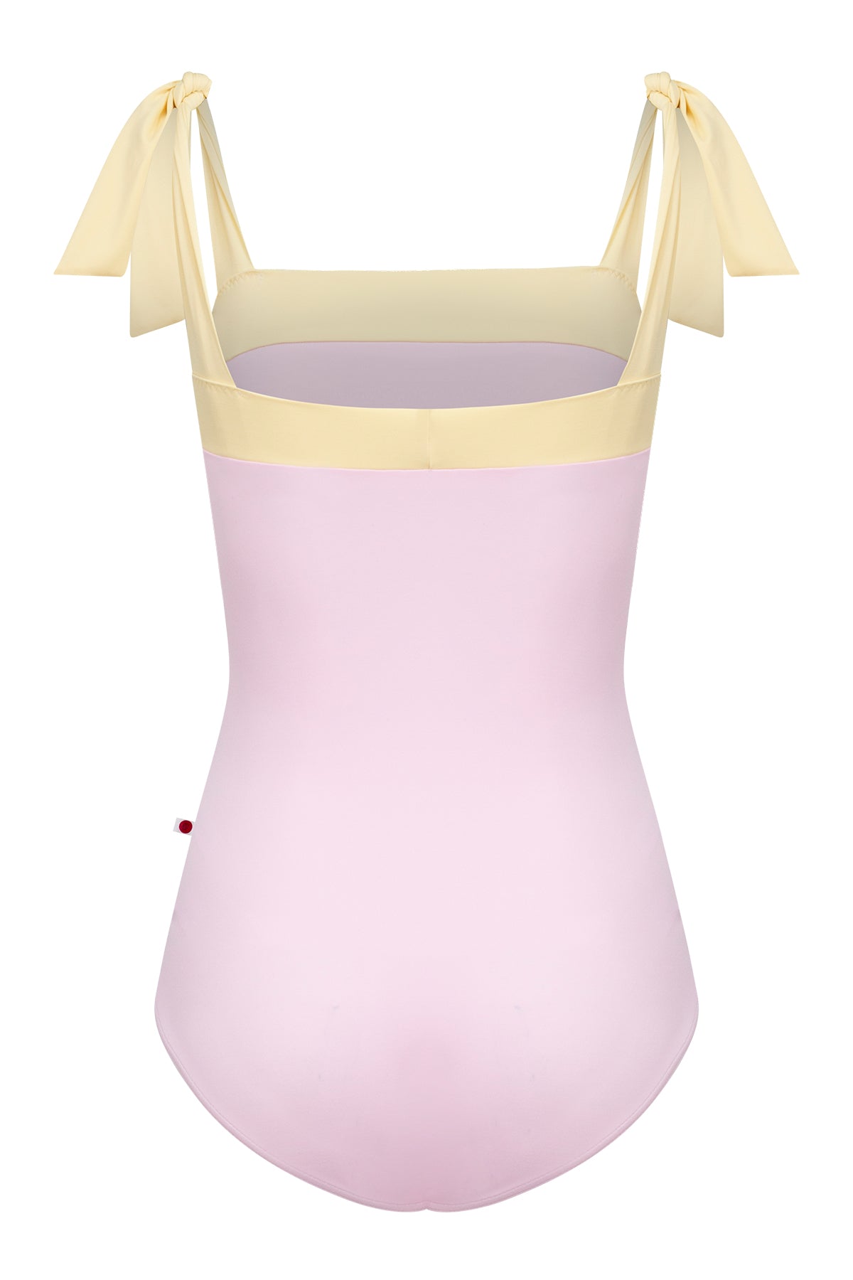 Mimi leotard, dusty pink body with a pale-yellow top band and knotted tie shoulder straps, square neckline.