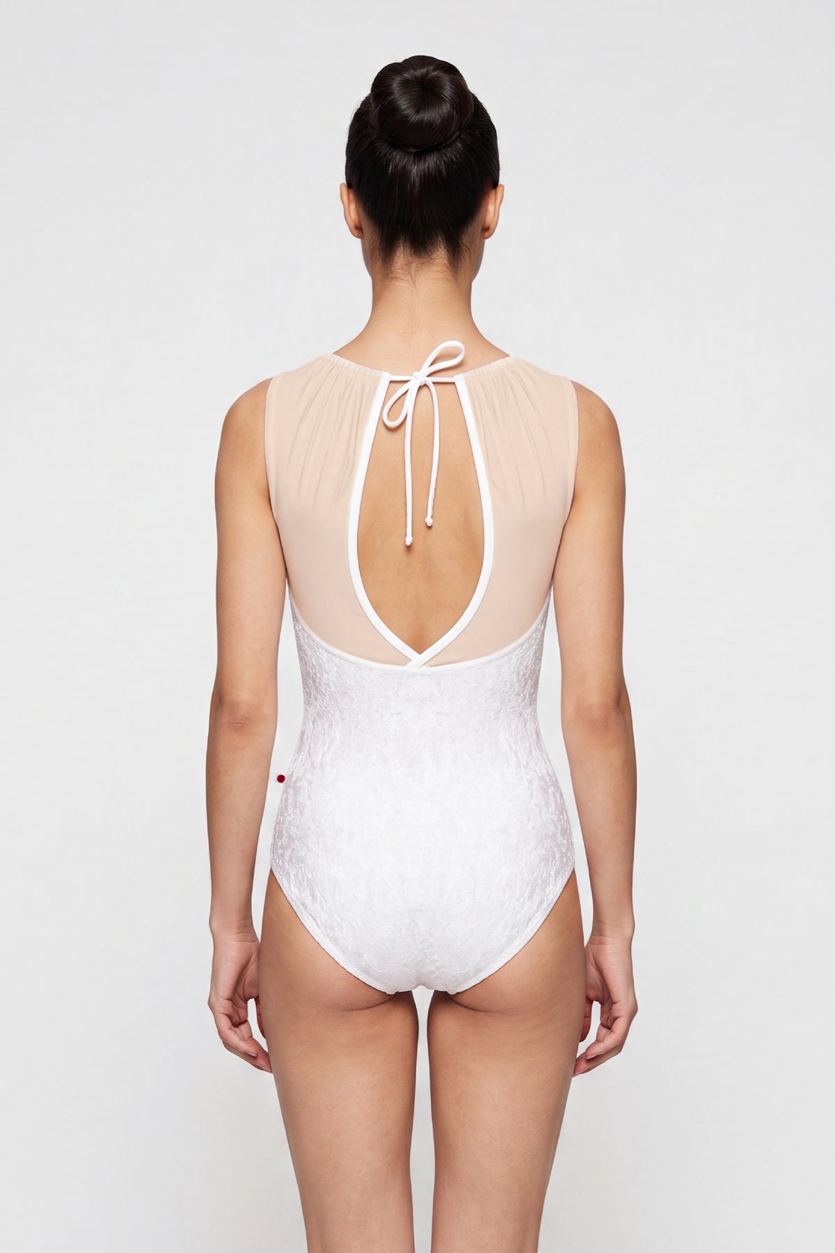 AI-generated model. Paris leotard in White, white velvet with a blush gathered mesh boat neckline.