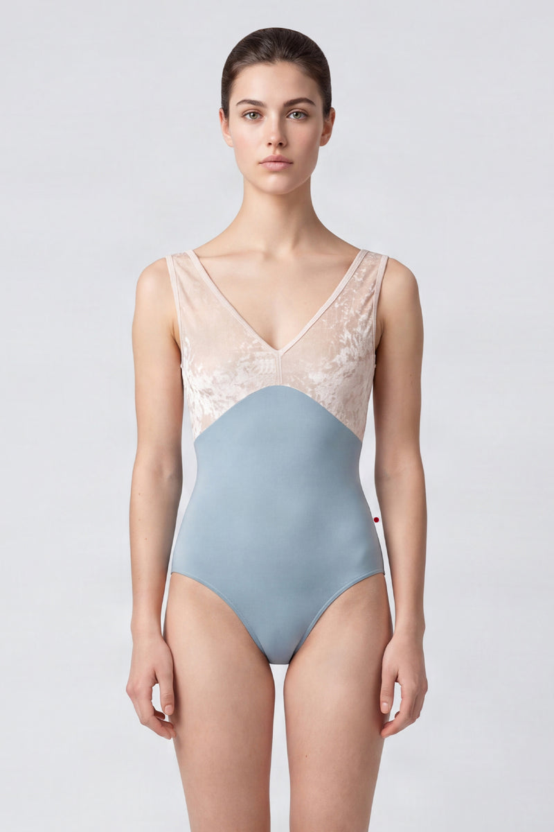 AI-generated model. Alicia leotard, blush crushed-velvet V-neck bodice and a dusty-blue body, wide straps.