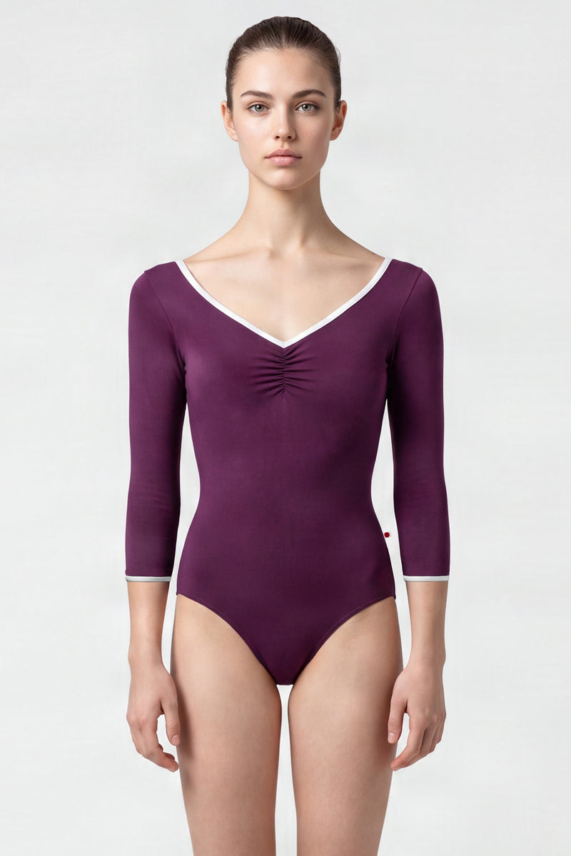 AI-generated model. Anna leotard, aubergine-purple with a ruched V-neck, silver trim and three-quarter sleeves.