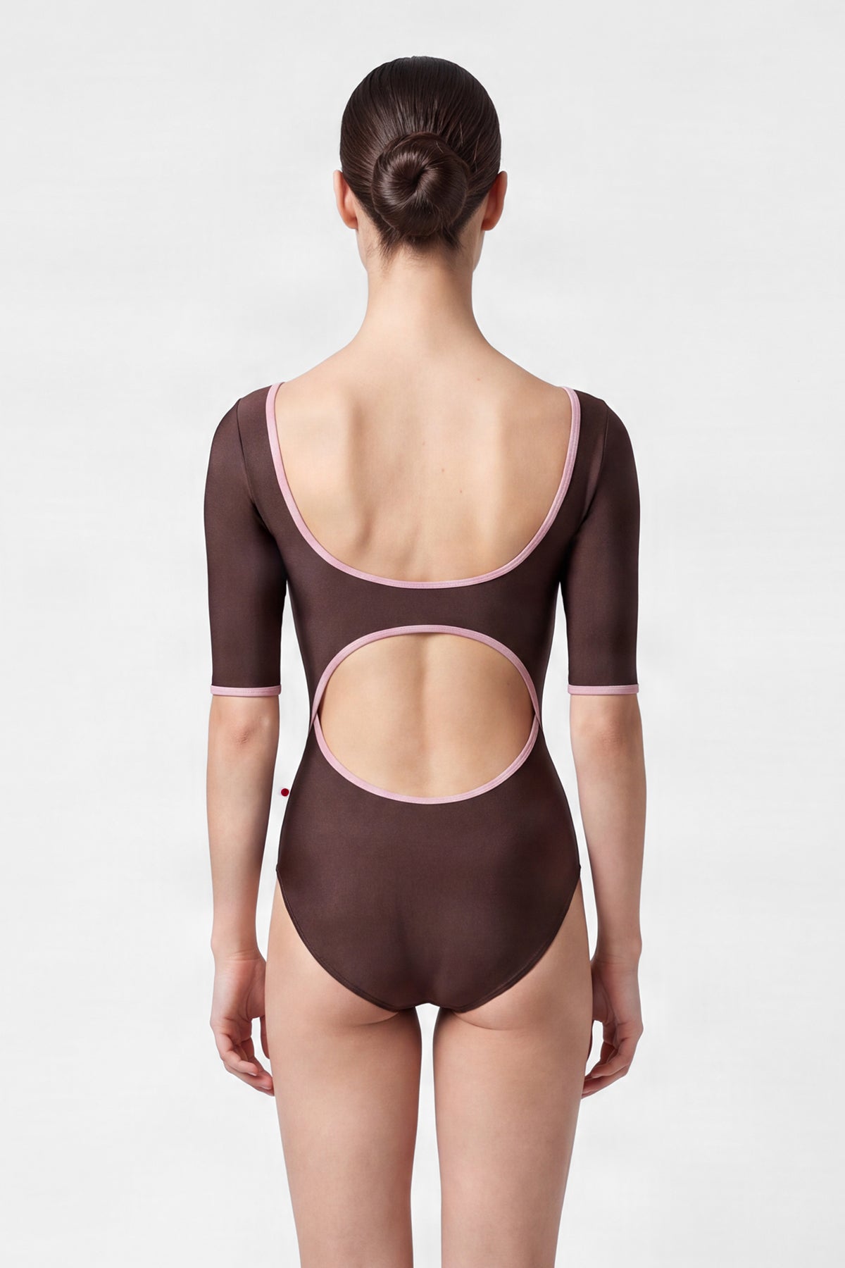AI-generated model. Veronique leotard, mocha-brown with a scoop neck, pink trim and three-quarter sleeves.